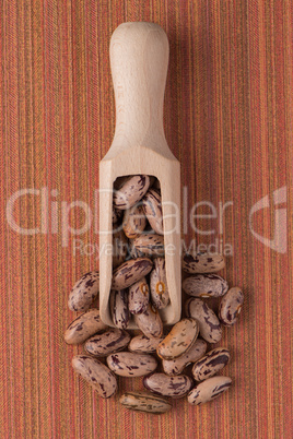 Wooden scoop with pinto beans