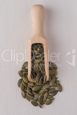 Wooden scoop with pumpkin seeds