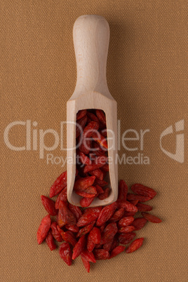 Wooden scoop with dry red goji berries