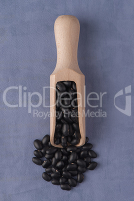 Wooden scoop with black beans