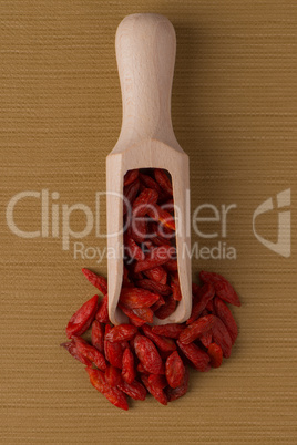 Wooden scoop with dry red goji berries