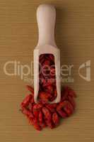 Wooden scoop with dry red goji berries