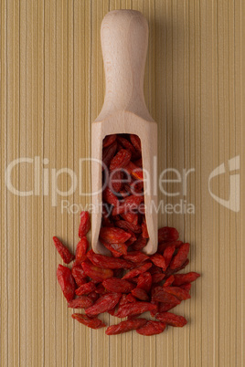 Wooden scoop with dry red goji berries