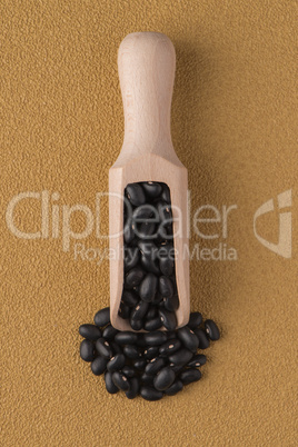 Wooden scoop with black beans