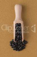 Wooden scoop with black beans