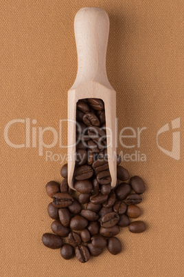 Wooden scoop with coffee beans