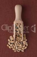 Wooden scoop with white beans