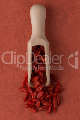 Wooden scoop with dry red goji berries