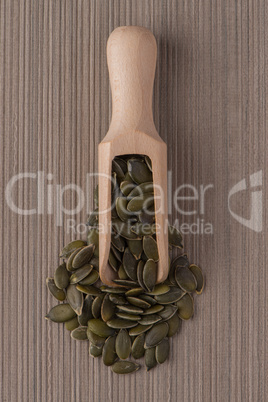 Wooden scoop with pumpkin seeds