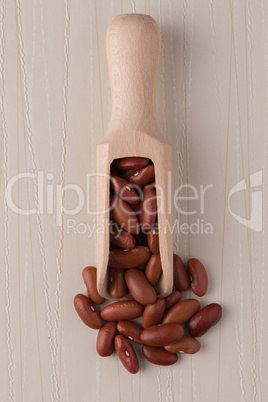 Wooden scoop with red beans