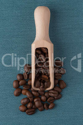 Wooden scoop with coffee beans