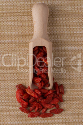 Wooden scoop with dry red goji berries