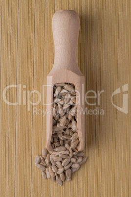 Wooden scoop with shelled sunflower seeds