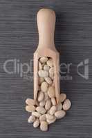 Wooden scoop with white beans