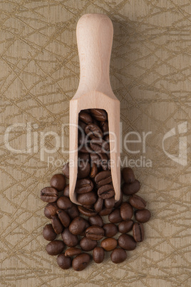 Wooden scoop with coffee beans