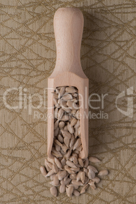 Wooden scoop with shelled sunflower seeds