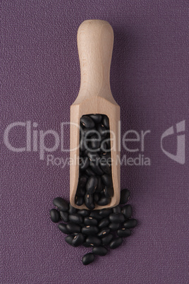 Wooden scoop with black beans