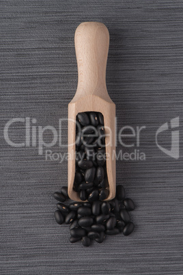 Wooden scoop with black beans