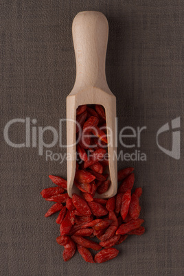 Wooden scoop with dry red goji berries