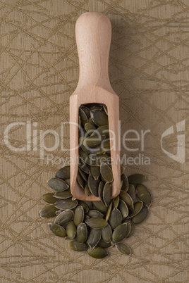 Wooden scoop with pumpkin seeds