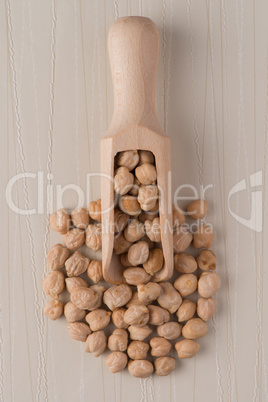 Wooden scoop with chickpeas