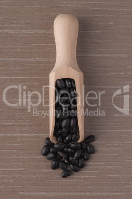 Wooden scoop with black beans