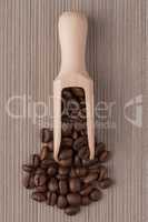 Wooden scoop with coffee beans