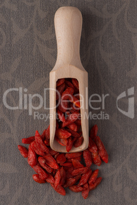 Wooden scoop with dry red goji berries