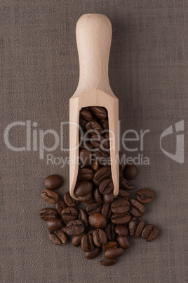 Wooden scoop with coffee beans