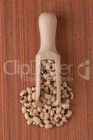 Wooden scoop with white beans