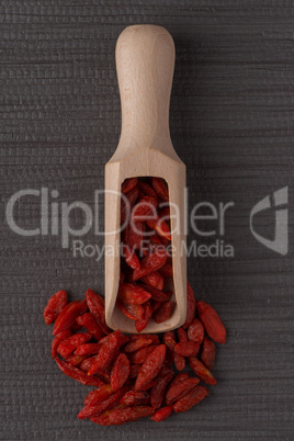 Wooden scoop with dry red goji berries