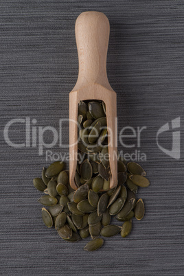 Wooden scoop with pumpkin seeds