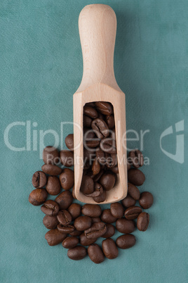 Wooden scoop with coffee beans