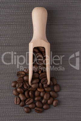 Wooden scoop with coffee beans