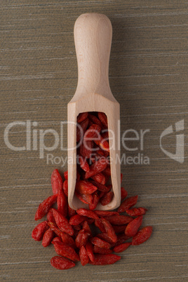 Wooden scoop with dry red goji berries