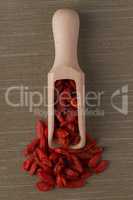 Wooden scoop with dry red goji berries