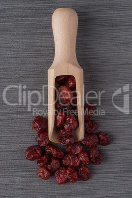 Wooden scoop with dried cranberries