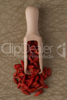 Wooden scoop with dry red goji berries