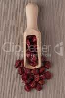 Wooden scoop with dried cranberries