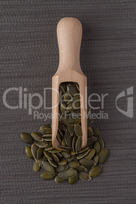 Wooden scoop with pumpkin seeds