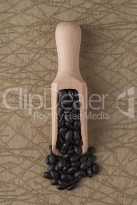 Wooden scoop with black beans