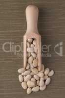 Wooden scoop with white beans