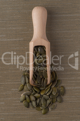 Wooden scoop with pumpkin seeds