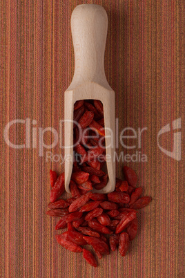 Wooden scoop with dry red goji berries