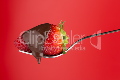 Strawberry and chocolate on a fork