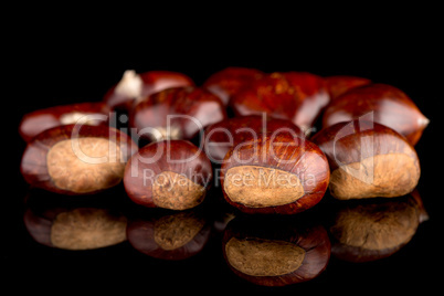 Chestnuts on a black reflective background