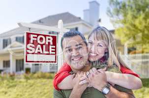 Couple in Front of For Sale Sign and House