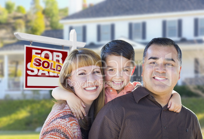 Young Family in Front of Sold Real Estate Sign and House
