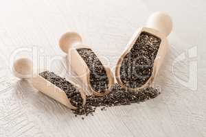 Chia seeds in wooden scoops