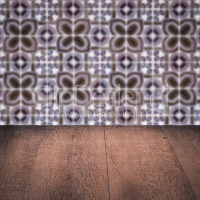 Wood table top and blur vintage ceramic tile pattern wall